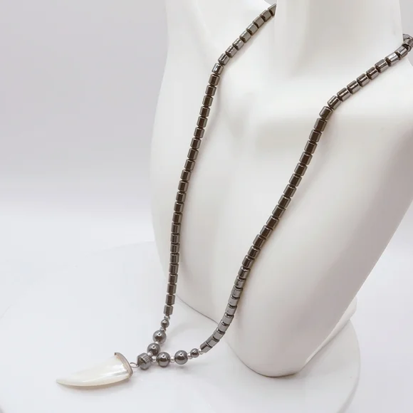 Hematite With Carved Mother Of Pearl Ivory Claw Pendant Necklace